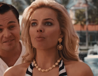 Margot Robbie opening her mouth in disbelief