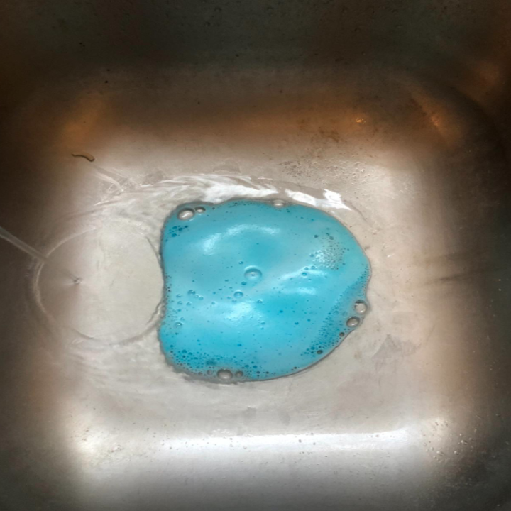 reviewer's garbage disposal slightly overflowing with the blue foam