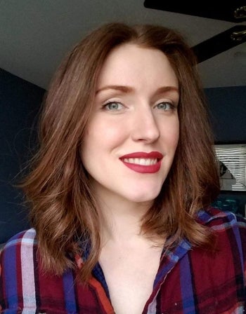 Reviewer with red matte lipstick on their face 