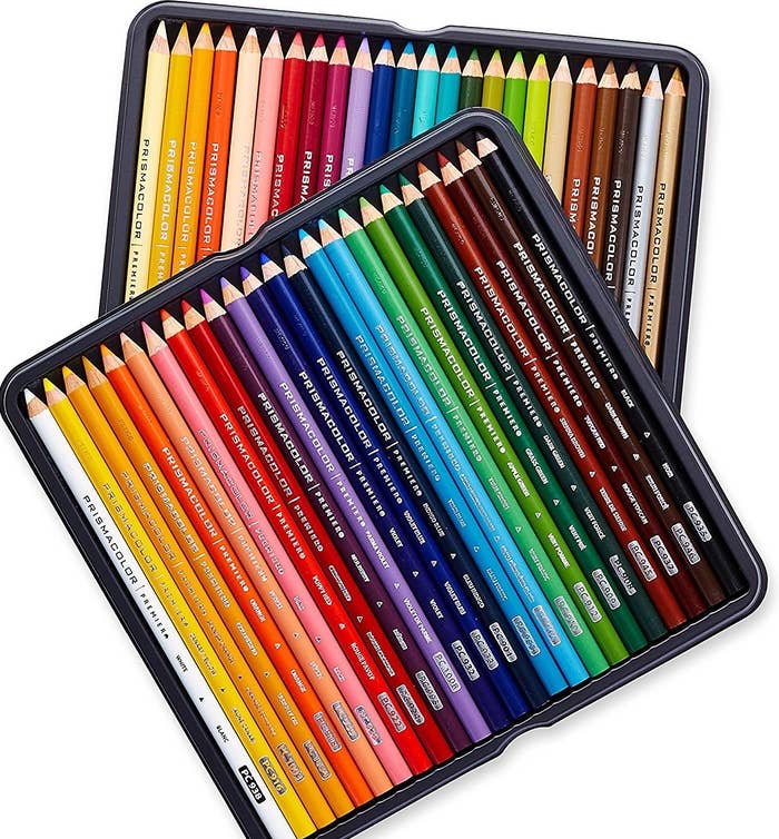Many colored pencils sitting in two square tins.