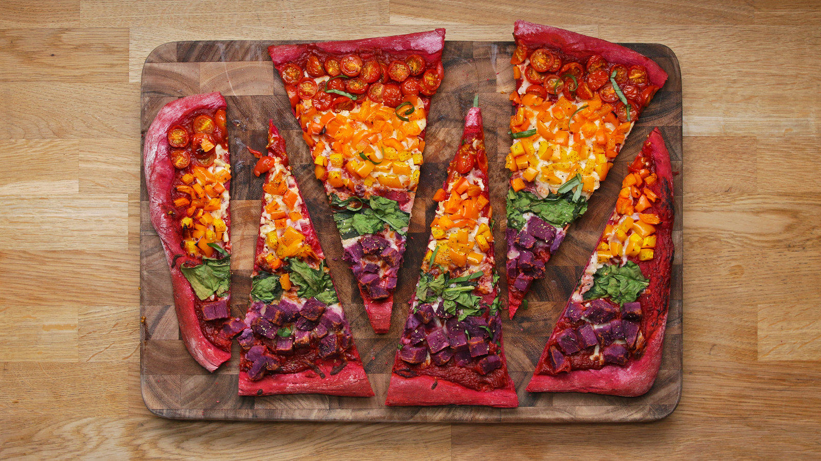 Servings: 5-6 INGREDIENTSDough (for 2 pizzas)1 tablespoon brown sugar1 cup warm water2 teaspoons active dry yeast1 cup pureed beets (about 4-5 small beets, roasted and peeled)3 tablespoons olive oil, divided2 teaspoons kosher salt4-5 cups all-purpose flourToppings (for 1 pizza)1½ tablespoons olive oil1½ cup pizza sauce1 cup shredded mozzarella cheese1 pint cherry tomatoes, halved1 orange bell pepper, diced1 yellow bell pepper, diced1 cup fresh spinach, chopped1 cup diced and roasted purple sweet potatoesSalt, to tastePepper, to taste1 teaspoon dried oreganoSliced fresh basil, for servingPREPARATIONIn a small bowl, combine half of the warm water and the brown sugar.Add the active dry yeast and let foam without stirring for about 8 minutes.In a large bowl, combine the pureed beets, 2 tablespoons of olive oil, salt, 2 cups of flour, and the yeast mixture. Rinse the yeast mixture bowl with the remaining ½ cup warm water to get all the yeast, and pour into the large bowl.Mix with your hands and gradually add 2-3 cups of flour until the dough comes together in a ball and is not moist to the touch.Transfer the dough to a floured surface and knead for about 5 minutes, until it becomes smooth and bouncy and does not stick to the surface. Add flour as needed.Pour the remaining tablespoon of olive oil in a clean large bowl and rub around with your fingers.Place the dough in the bowl and turn to coat with the oil.Cover with a kitchen towel or a plastic wrap and let rise for at least 1 hour at room temperature (preferably warm). The dough should double in size.Preheat the oven to 500°F (260°C).Grease a nonstick baking sheet with the olive oil.Place the dough on a floured surface and divide in half.Save one dough half for later. It will keep in the refrigerator for up to 2 weeks in a bowl covered tightly with plastic wrap.Using a rolling pin, flatten the remaining ball of dough into a rectangular shape that will approximately fit on the baking sheet.Transfer the dough to baking sheet and stretch as needed to cover the pan.Leaving a 1-inch border all around the sides, spread the pizza sauce over the dough and sprinkle with mozzarella.Add strips of cherry tomatoes, orange bell pepper, yellow bell pepper, spinach, and roasted purple sweet potatoes.Season with salt, pepper, and oregano.Bake for 7-10 minutes, until the veggies are tender and the crust is cooked.Sprinkle with fresh basil, then slice and serve.Enjoy!Inspiration:http://www.bakersroyale.com/beet-crust-pizza/https://www.tastemade.com/videos/beet-crust-pizza