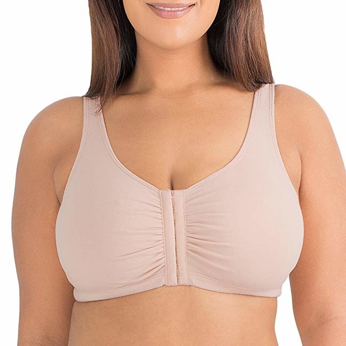 model wearing the front-close sports bra in beige