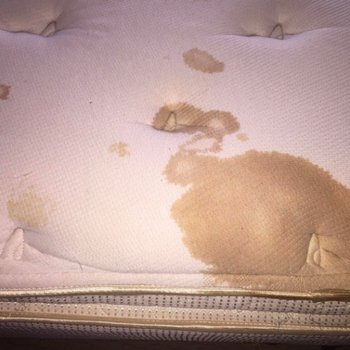 before of a reviewer's mattress with a large brown stain