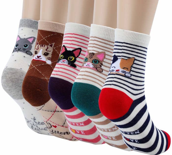 The five socks in different colors, each with contrasting heel and toe colors and different kitties peeking over the heel. Three of the pairs are striped, one has little polka dots, and another has checks