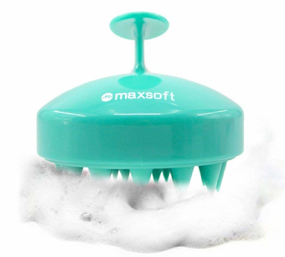 silicone brush with teeth-like parts on the bottom and a handle on top