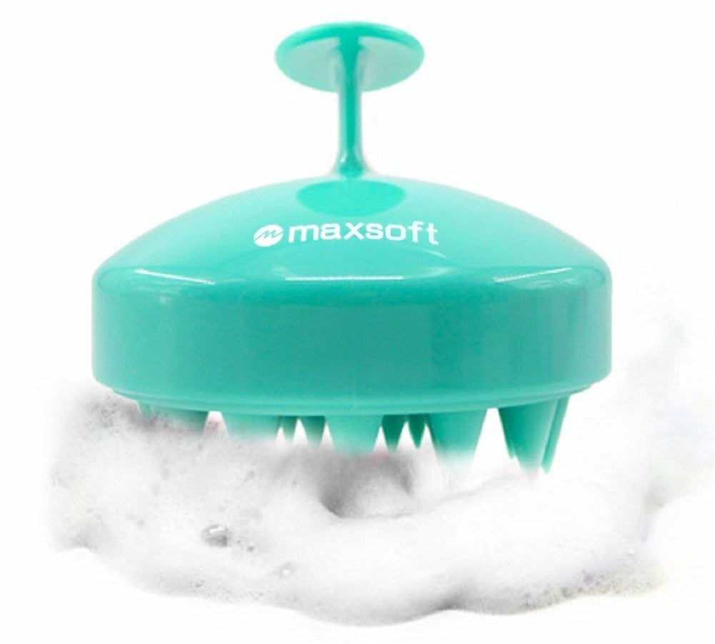 silicone brush with teeth-like parts on the bottom and a handle on top