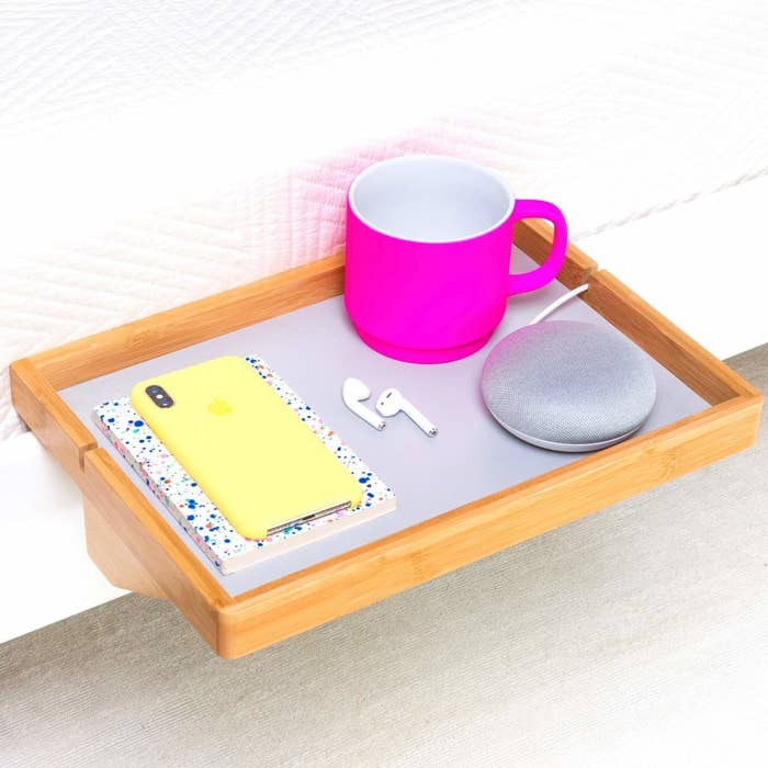 Promising review: "This product exceeded my expectations. I was impressed by the sturdy bamboo and was able to easily assemble the shelf quickly without help. Ever since I attached it to my bed, it has given me an excuse to just lay in bed and watch Netflix because I can lay on my stomach while I rest my laptop on the BedShelfie and not have to worry about falling asleep and having my laptop knocked off my bed." —Amazon Customer Get it from Amazon for $29.99+ (available in light green/blue, natural wood, natural wood/grey, and light rose).