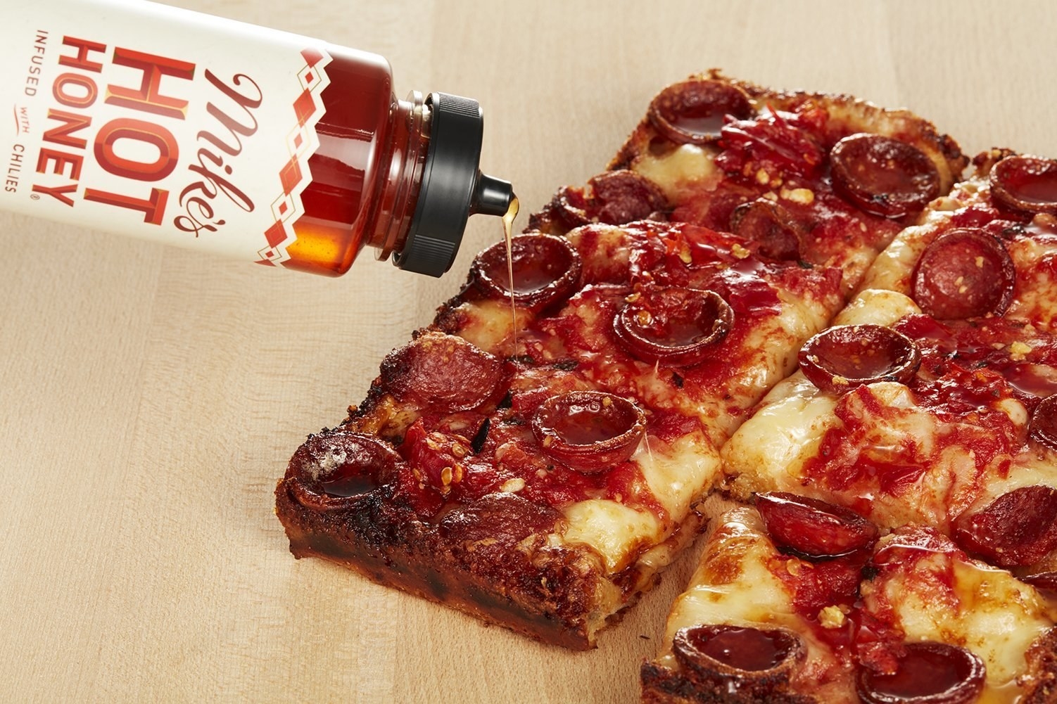 Mike&#x27;s Hot Honey drizzled on pepperoni pizza