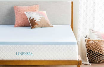 memory foam mattress topper on a bed