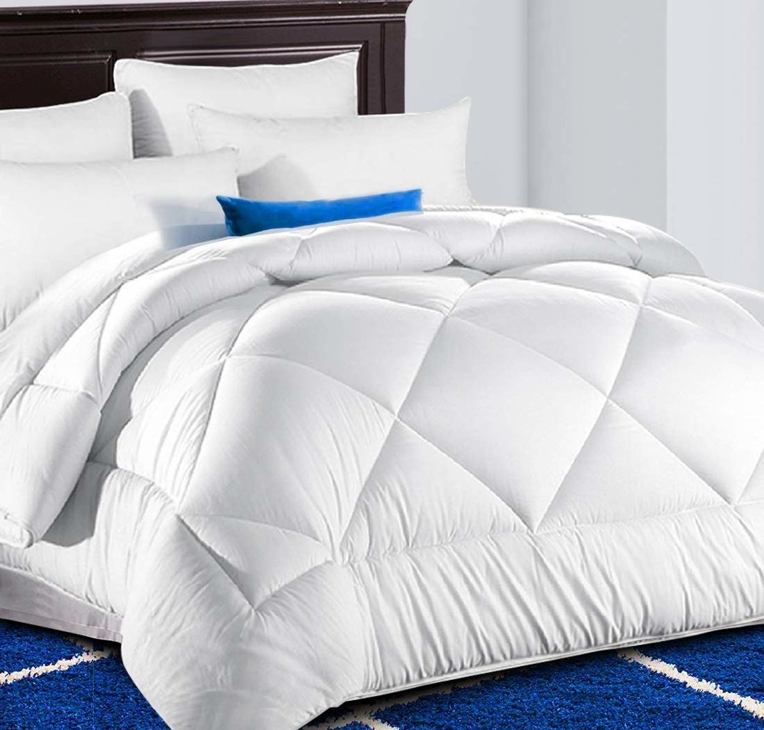 a fluffy white comforter on a bed