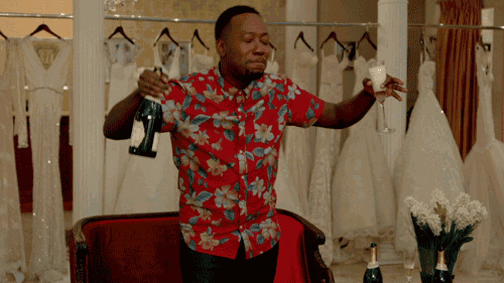 GIF of person dancing with champagne bottle and glass