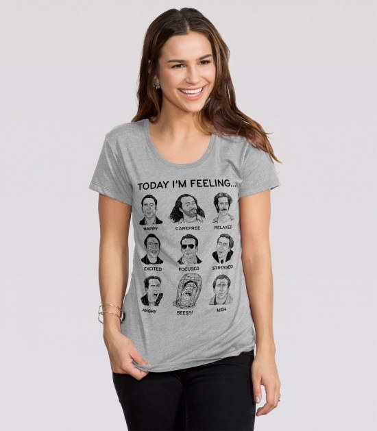 A model in the tee with text &quot;today I&#x27;m feeling&quot; and nine illustrations of Nic Cage in different movies to illustrate different emotions