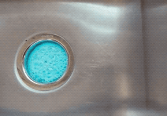 a moving gif of the blue foaming cleanser at work in a sink