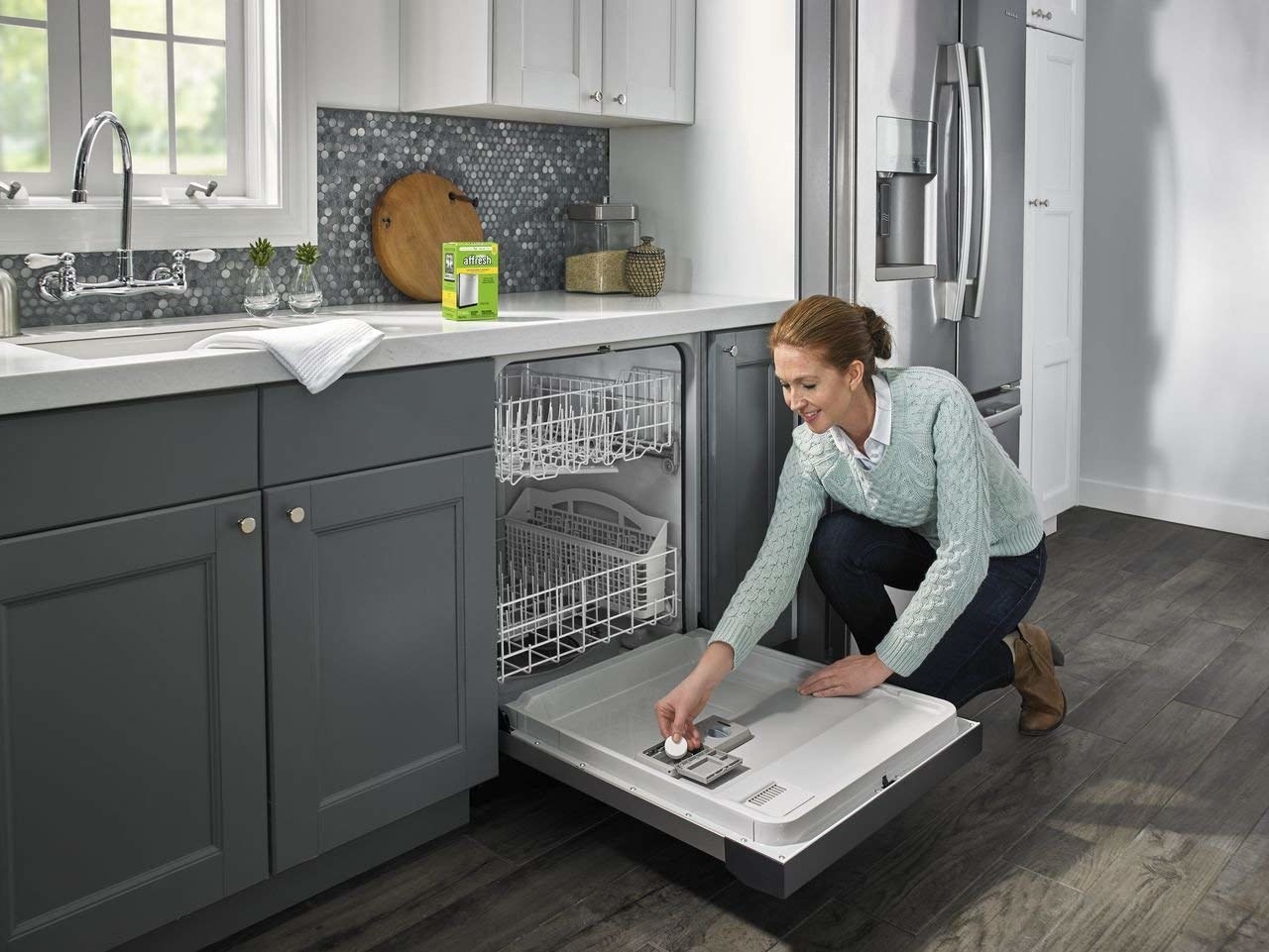model putting cleaning tablet in dishwasher