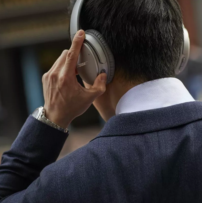 model wearing silver bose headphones 