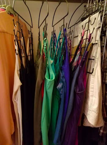A side-view customer review photo of the Tank Top Hangers holding all their tops