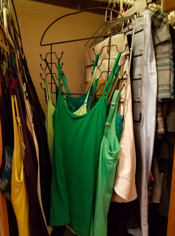 A front-view customer review photo of the Tank Top Hangers holding all their tops