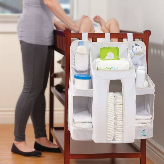 The diaper caddy attached to the side of a changing table