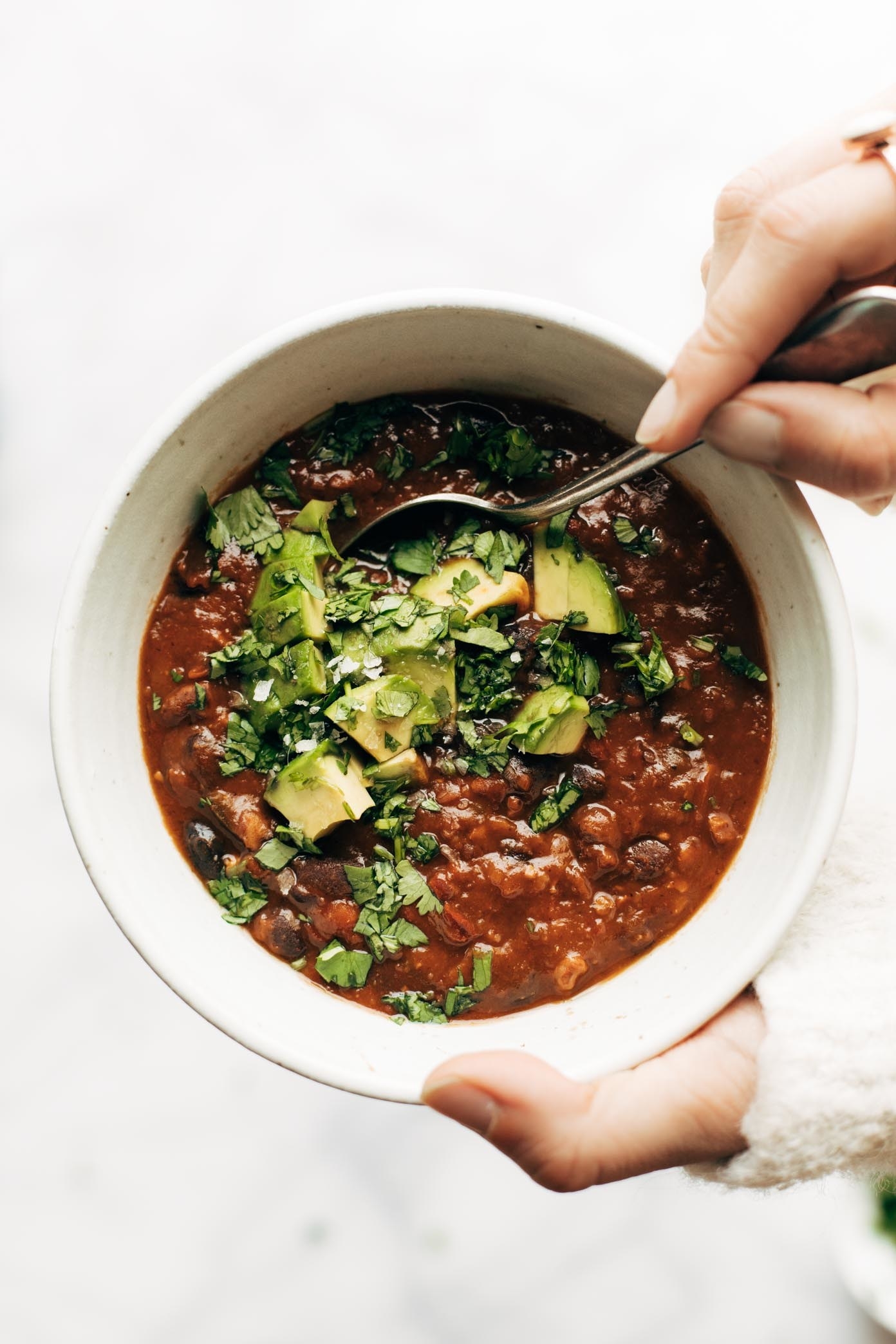 bowl of chili with avocado in the middle