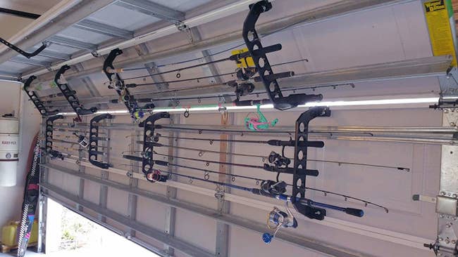 inside of a car garage door with racks that hang fishing poles horizontally without disturbing the use of the garage doors