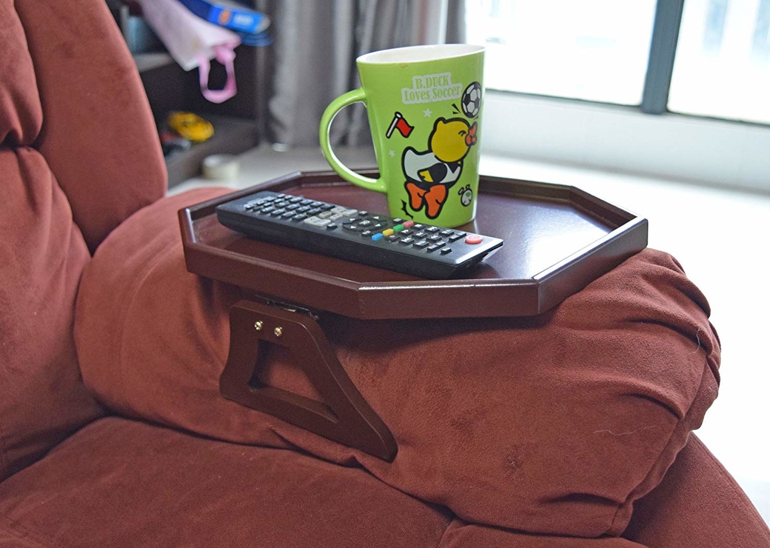 the hexagon-shaped table attached to the couch arm