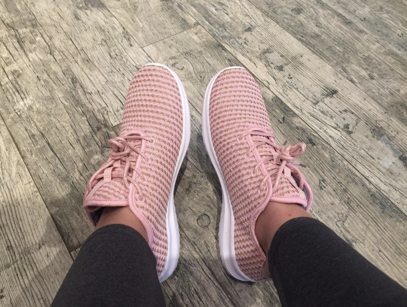 reviewer wearing the pink knit lace-up sneakers