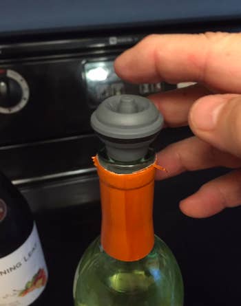a reviewer photo of the wine vacuum stopper on the bottle of wine