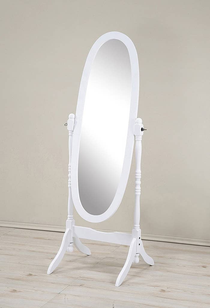 A round white full-length mirror