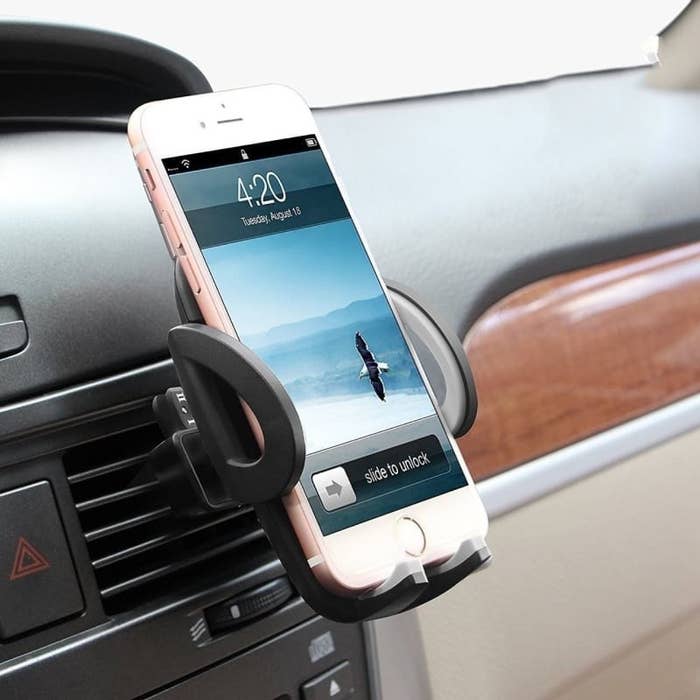 A phone holder attached to the car vent