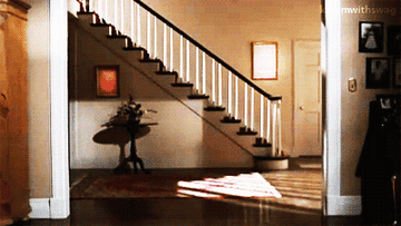 A gif of Tom Cruise sliding across the floor in his underwear, socks, and a shirt