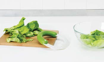 The chopper next to a cutting board of lettuce