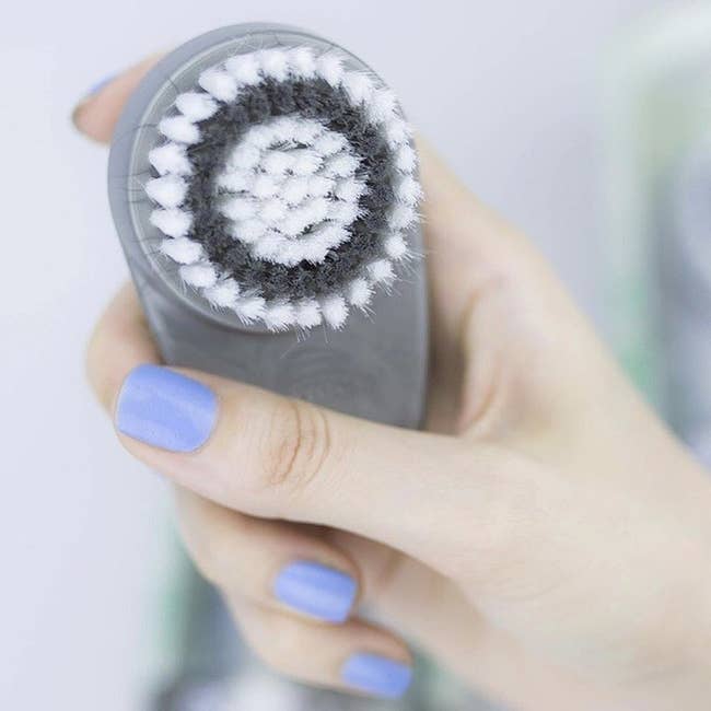Grey and white cleansing brush