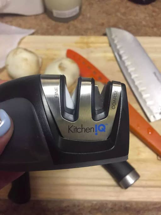 hand holding up the knife sharpener to show the two sharpening niches