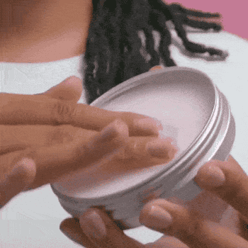 Gif of model using the cleansing balm to wash her face 