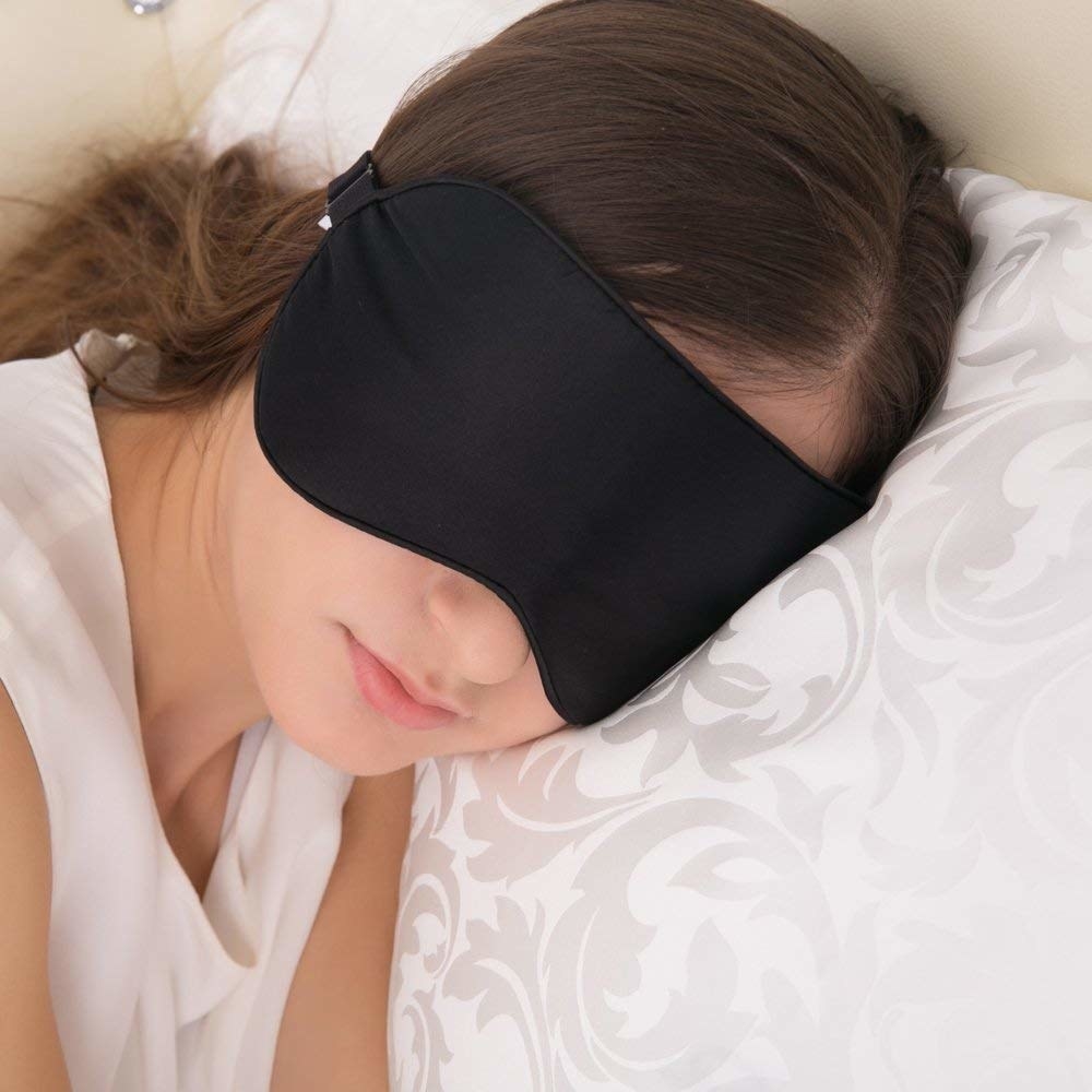 A person wearing the eye mask as they sleep