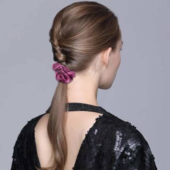 a model with a velvet scrunchie in their hair