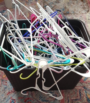 A reviewer showing a bin full of hangers