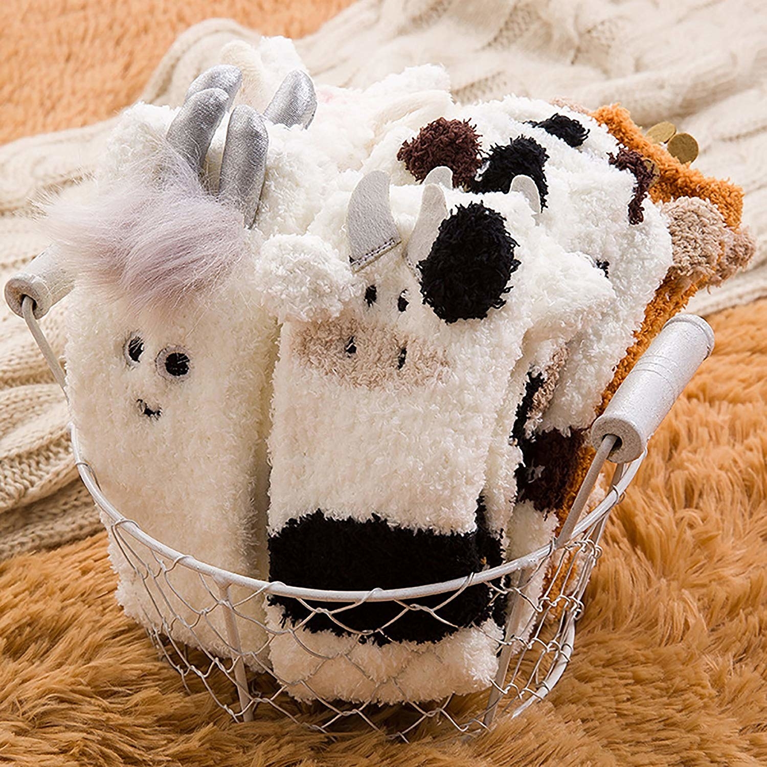 A variety of the fuzzy socks folded in a basket