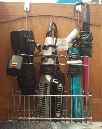 the same hair tools neatly stored in a metal wire basket hanging organizer