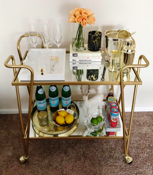 reviewer photo of their fully stocked gold bar cart