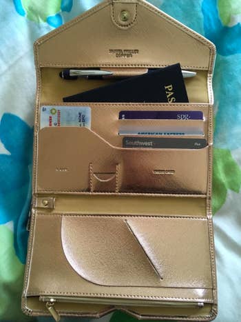 reviewer image of the wallet open showing different pockets for cards, passport, documents