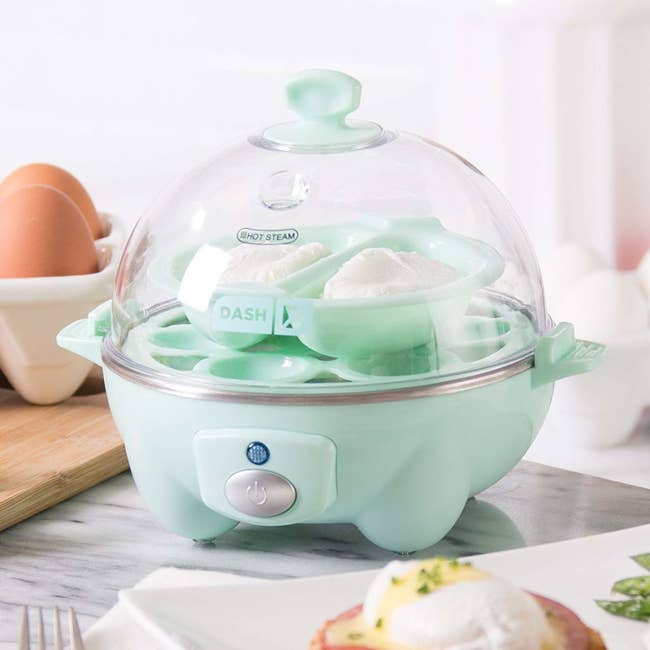 the green egg cooker which has a clear domed lid