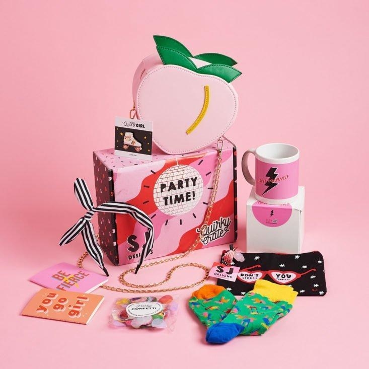 pink box with socks, a mug, a peach-shaped purse, and other colorful items