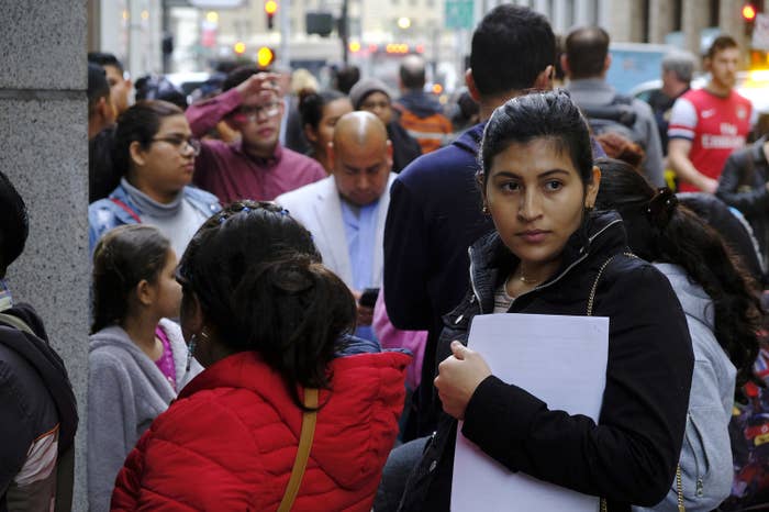 Hundreds of people overflow onto the sidewalk in a line snaking around the block outside a US immigration office with numerous courtrooms in San Francisco.