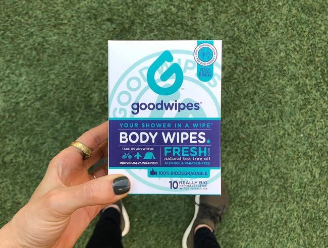 Reviewer holding body wipes in hand