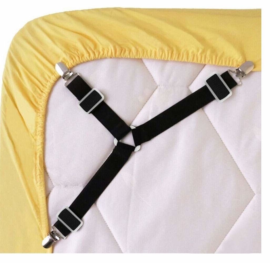 suspenders that attach to the corner of a fitted bedsheet underneath the mattreess