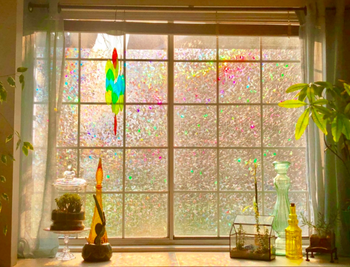 Reviewer's photo of the privacy window film with colorful light streaming through a large window 