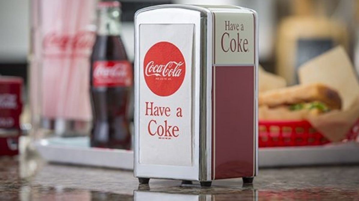 the napking dispenser with the coca cola logo