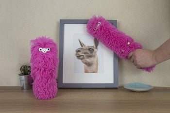 fuzzy pink duster with eye and nose to look like a llama