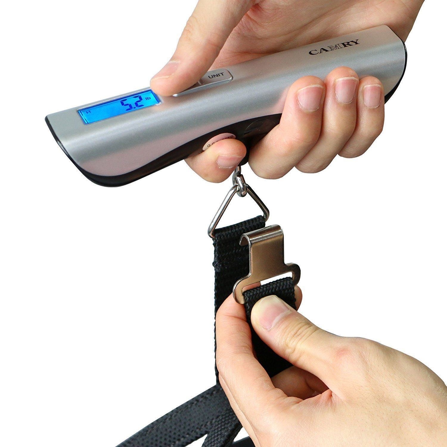 Model's hand holding the digital scale